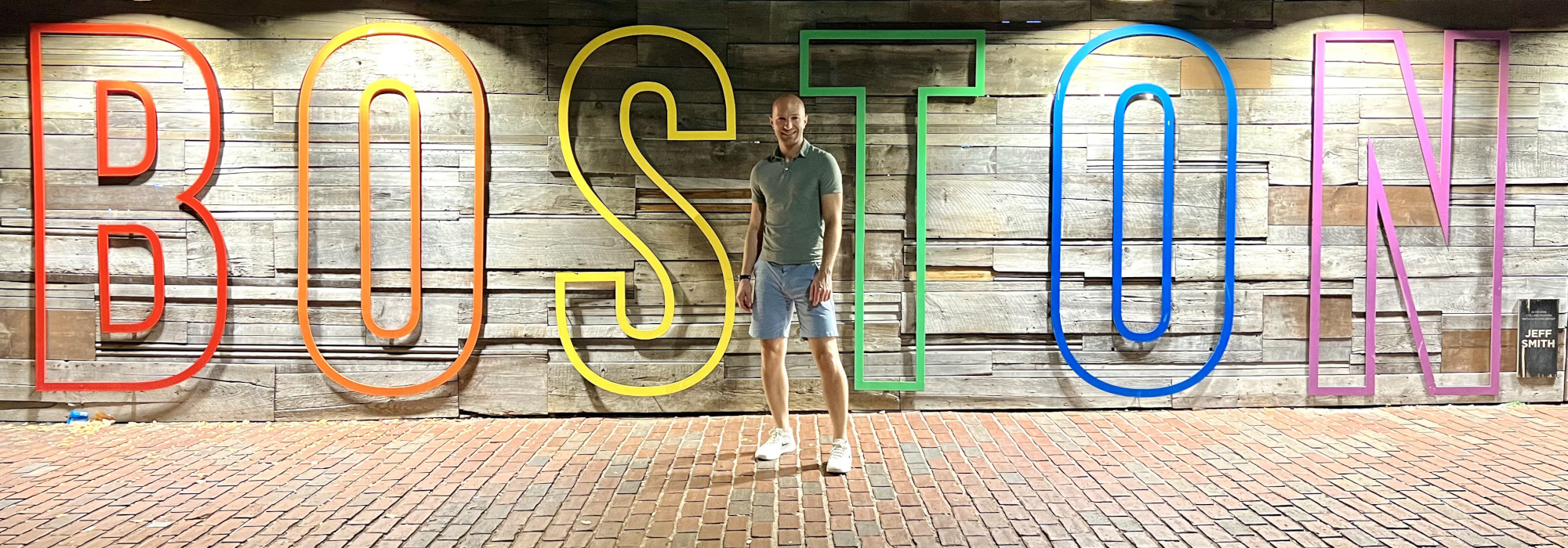 A photo of me standing in front of a textual art installation that says "Boston".